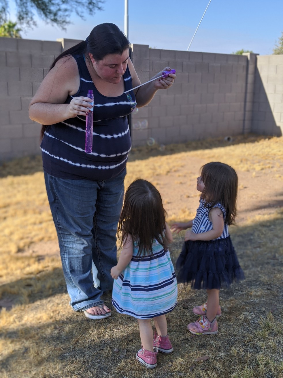 The twins playing with bubbles with one of their Aunties